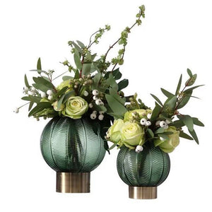 Pair of Green Palm Vases with orchids on white backdrop