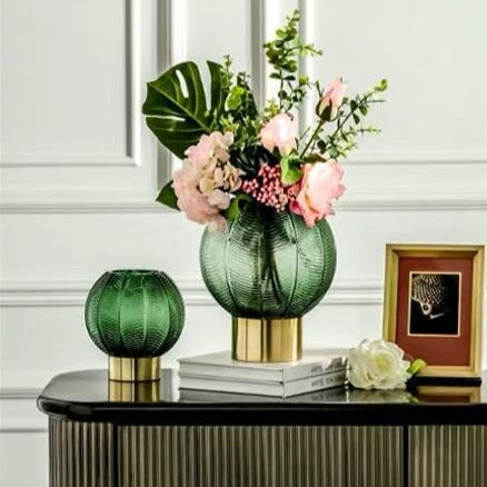 Pair of Green Palm Vases on side table lifestyle image one with flowers, one without