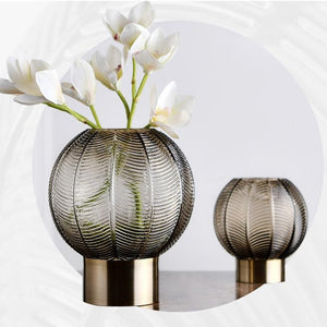 Pair of Smoky Quartz Palm Vases with orchids on white backdrop